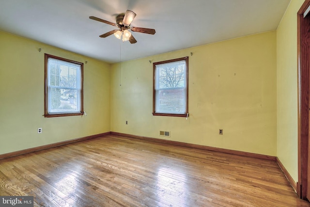 empty room with ceiling fan and light wood-type flooring