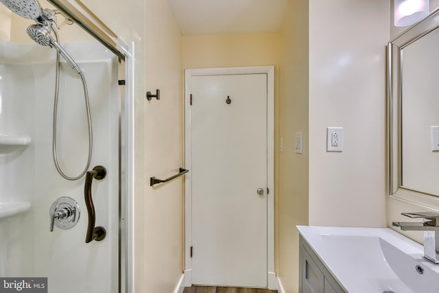 bathroom with vanity and a shower