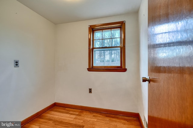 empty room with light hardwood / wood-style flooring