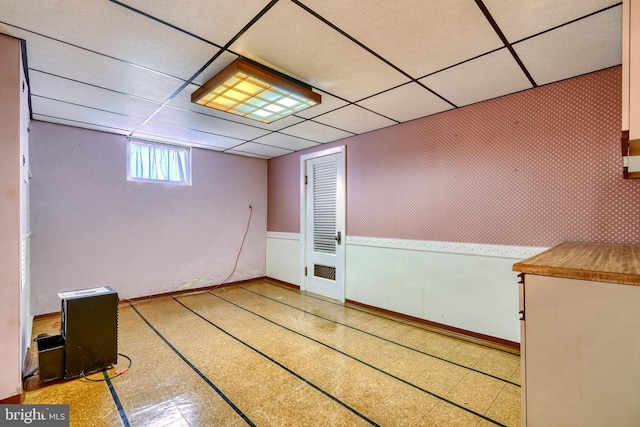 basement featuring a paneled ceiling