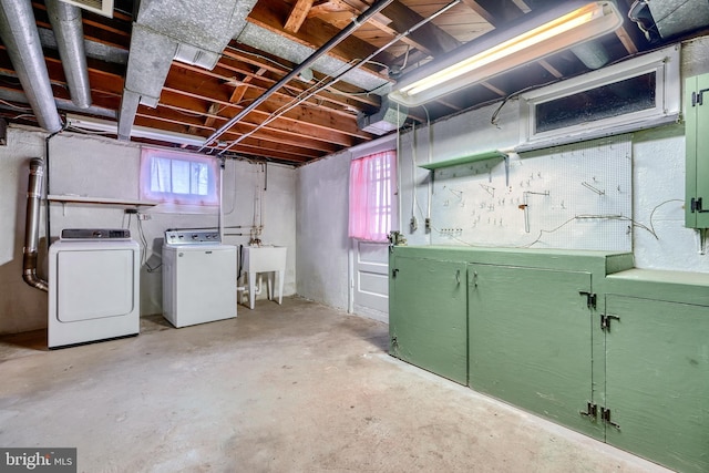 basement featuring independent washer and dryer, sink, and a workshop area