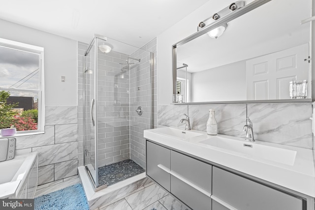 bathroom with tile walls, vanity, and walk in shower