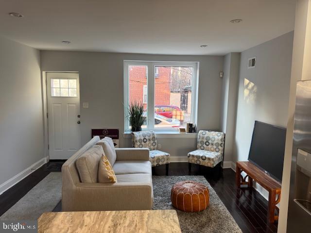 living room with dark hardwood / wood-style flooring