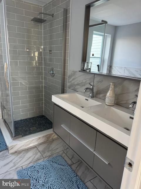 bathroom with vanity and a shower with shower door