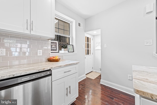 kitchen featuring white cabinetry, dishwasher, decorative backsplash, light stone countertops, and dark wood-type flooring