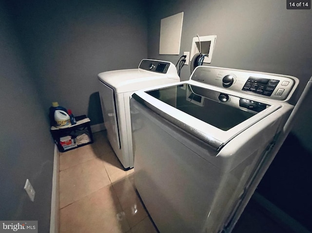 laundry room with separate washer and dryer and tile patterned floors