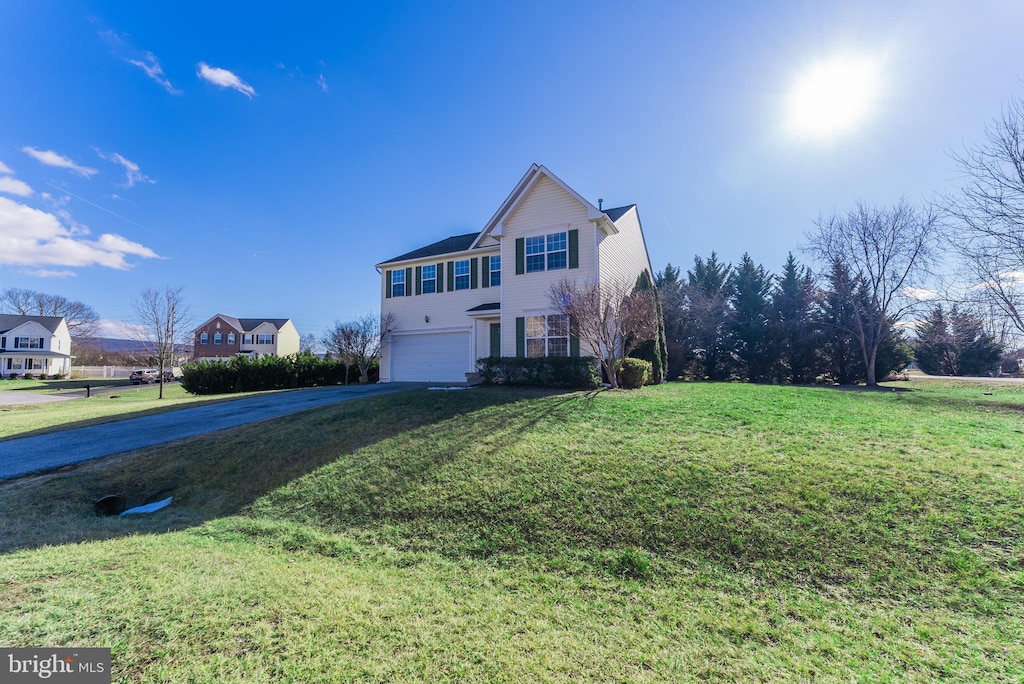 view of front property with a garage and a front lawn