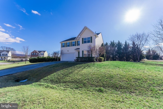 front facade with a garage and a front lawn