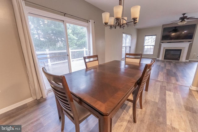 dining space featuring wood-type flooring and a chandelier