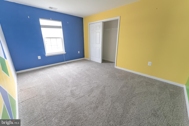 unfurnished bedroom featuring a closet and carpet