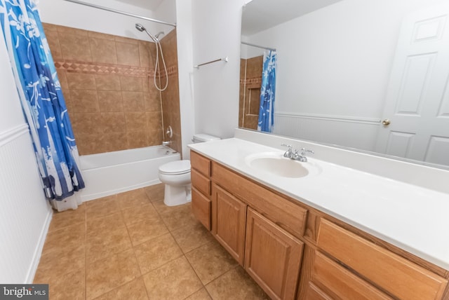 full bathroom featuring tile patterned floors, toilet, shower / bath combo with shower curtain, and vanity