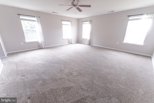 unfurnished room with ceiling fan and light colored carpet