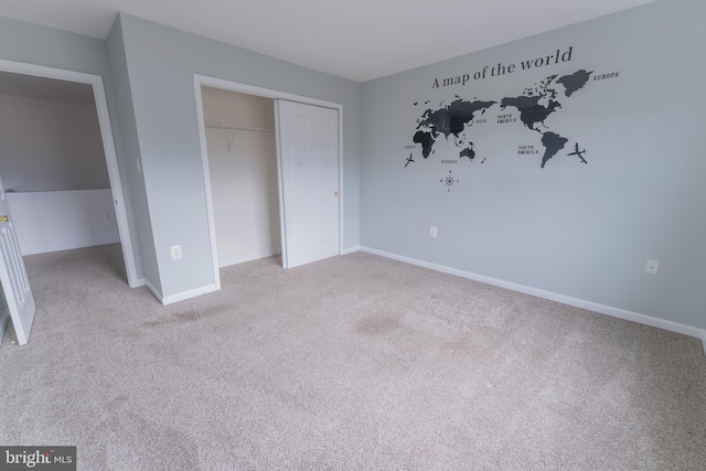 unfurnished bedroom with light carpet and a closet