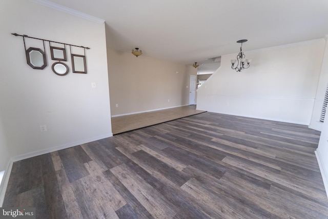 interior space featuring dark wood-type flooring, crown molding, and an inviting chandelier