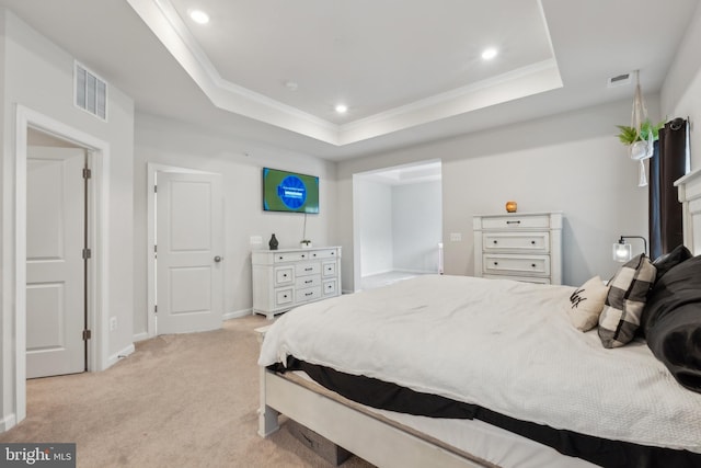 bedroom featuring light carpet, crown molding, and a raised ceiling