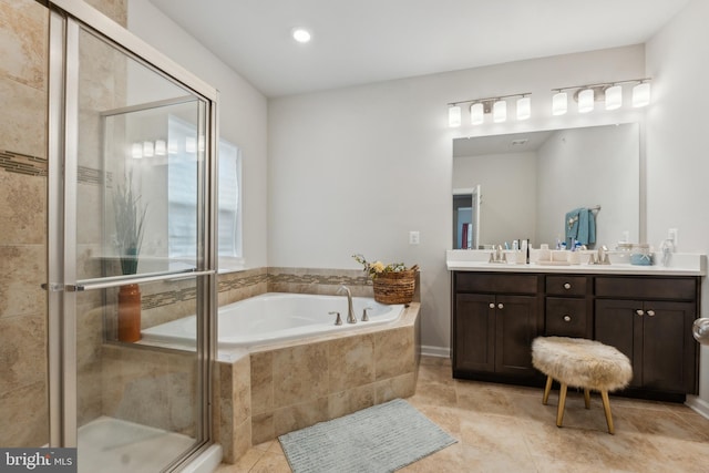 bathroom with shower with separate bathtub, tile patterned floors, and vanity