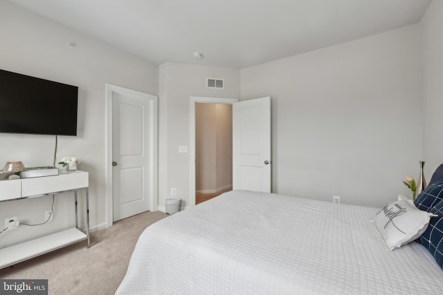 bedroom with light colored carpet