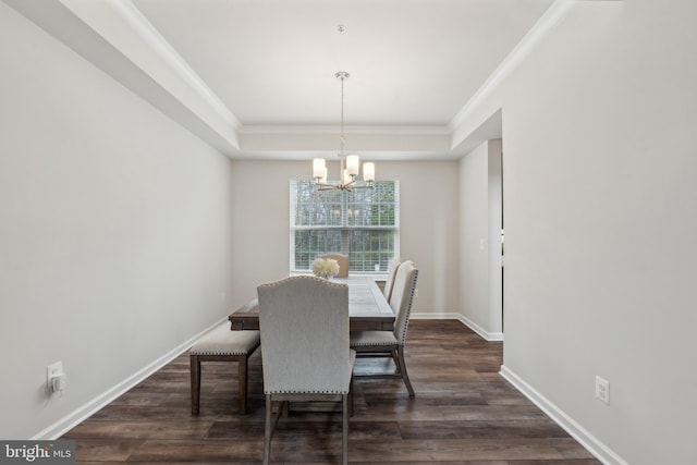 dining space with an inviting chandelier, crown molding, dark wood-type flooring, and a tray ceiling