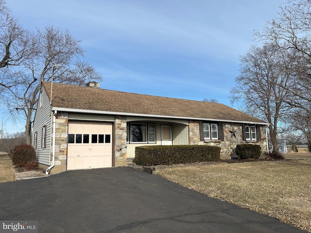 single story home featuring a garage and a front yard