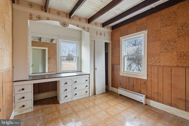 bathroom with parquet floors, plenty of natural light, beam ceiling, and a baseboard heating unit