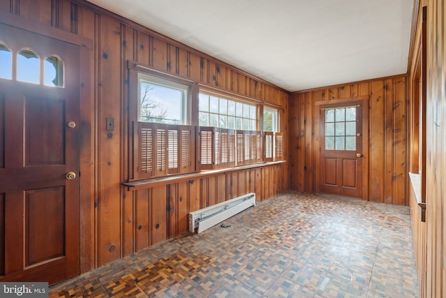 entrance foyer with a baseboard radiator and wooden walls