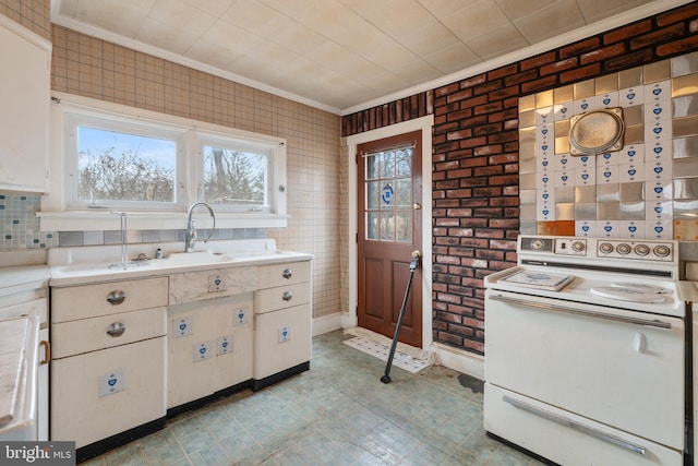 kitchen featuring electric stove, a healthy amount of sunlight, crown molding, and white cabinets