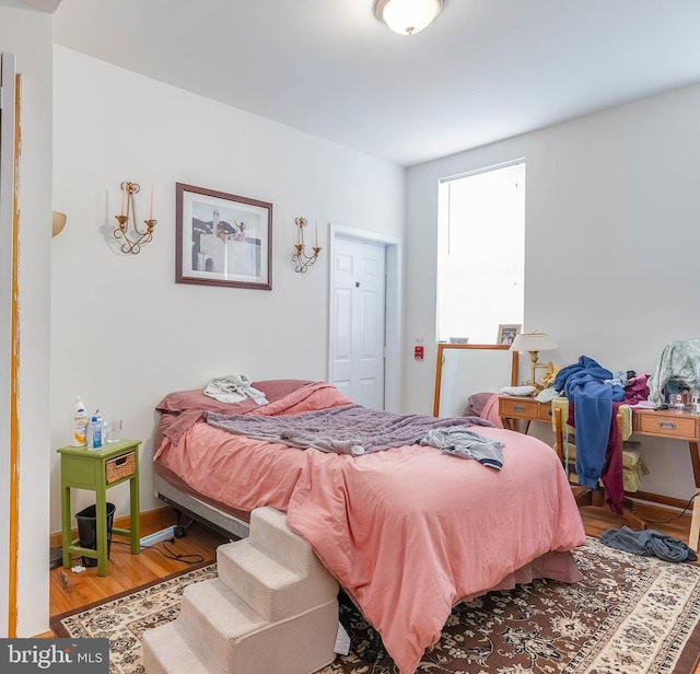 bedroom with hardwood / wood-style flooring