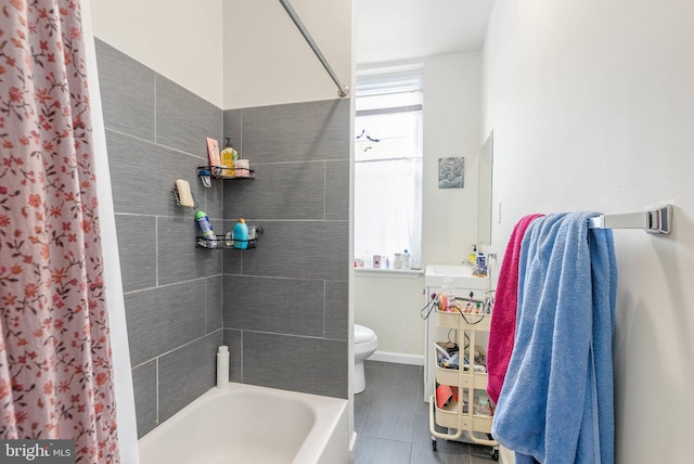 bathroom with toilet and shower / bath combo