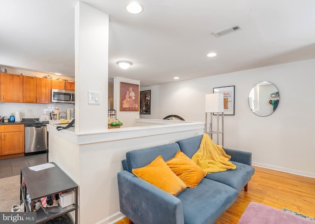 living room with light hardwood / wood-style flooring