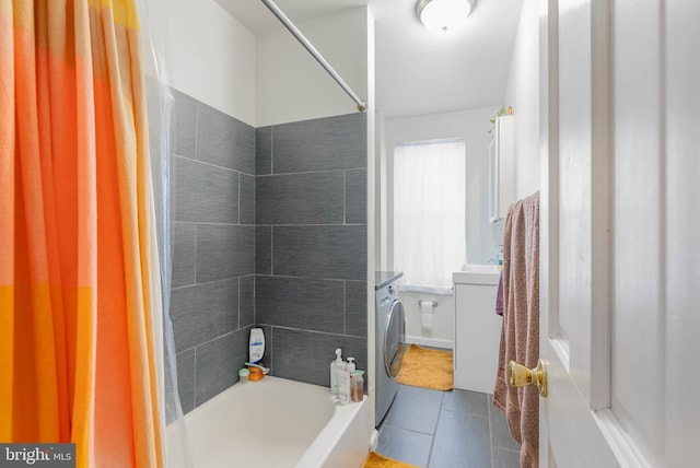 bathroom featuring shower / bath combination with curtain, tile patterned floors, washer / clothes dryer, and vanity