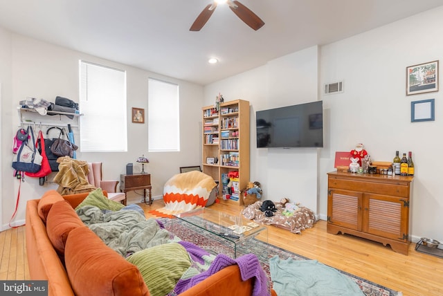 living room with hardwood / wood-style flooring and ceiling fan