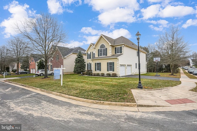 front facade with a garage and a front yard