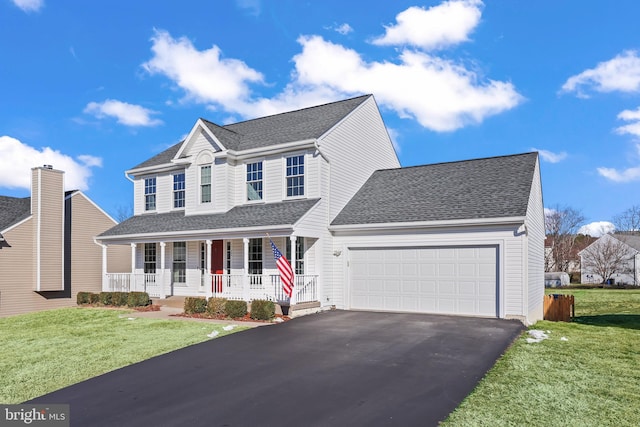 view of front of home with covered porch, a front yard, and a garage