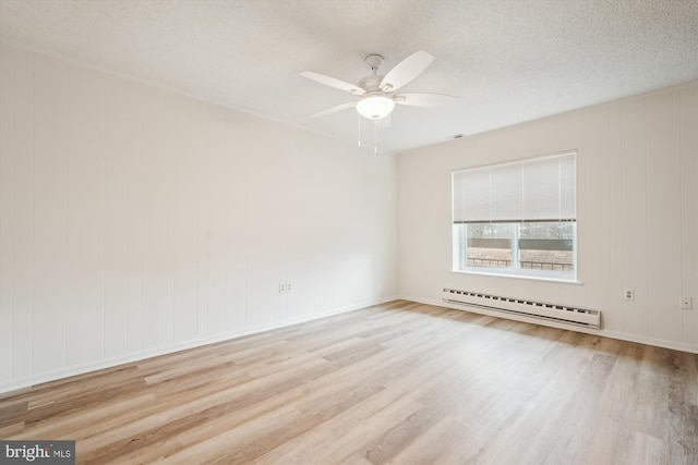 unfurnished room featuring a ceiling fan, a baseboard radiator, a textured ceiling, and wood finished floors