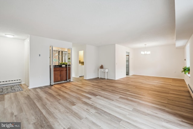 unfurnished living room with a baseboard radiator, light wood-style flooring, and a chandelier