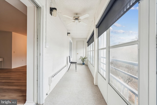 hallway featuring a baseboard radiator and a textured ceiling