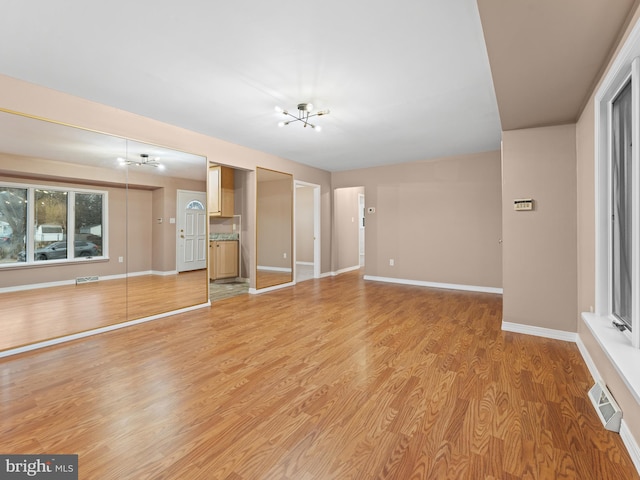 unfurnished living room with hardwood / wood-style floors