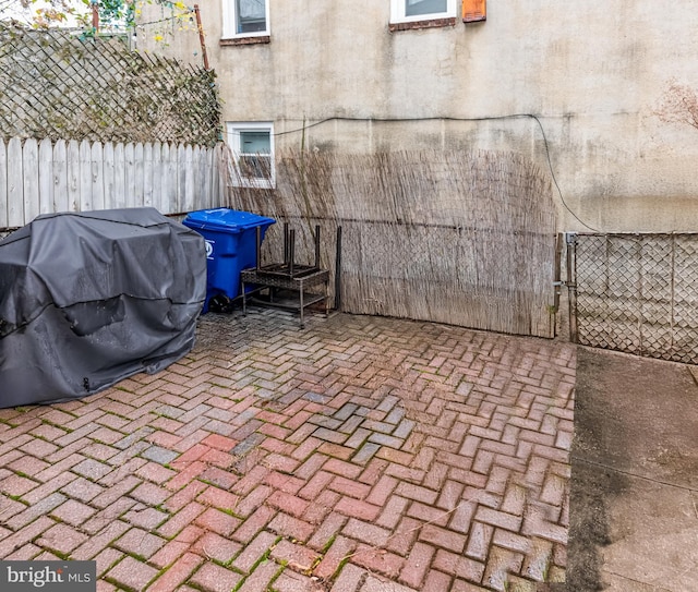 view of patio featuring fence and area for grilling