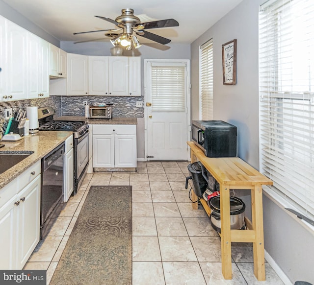 kitchen featuring light tile patterned floors, stainless steel gas range oven, white cabinetry, black dishwasher, and decorative backsplash