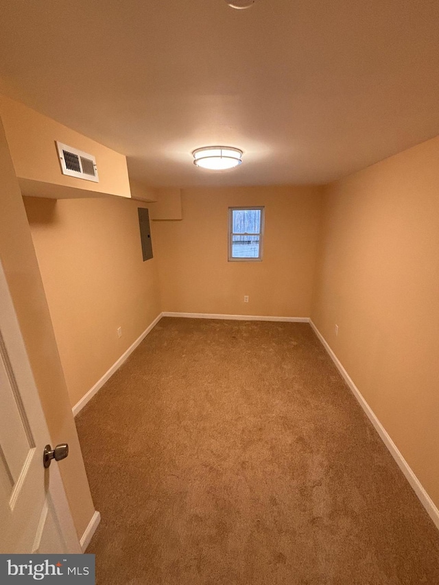 basement featuring carpet floors and electric panel