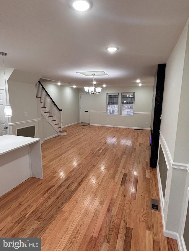 interior space featuring light hardwood / wood-style floors and a notable chandelier