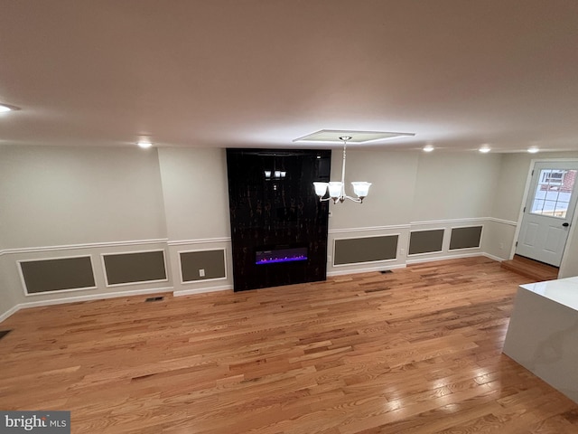 entryway with wood-type flooring and a chandelier