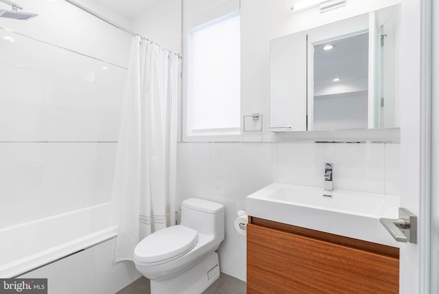 full bathroom featuring vanity, shower / bath combo, and toilet