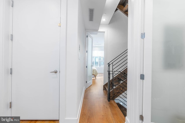 hallway with light hardwood / wood-style flooring