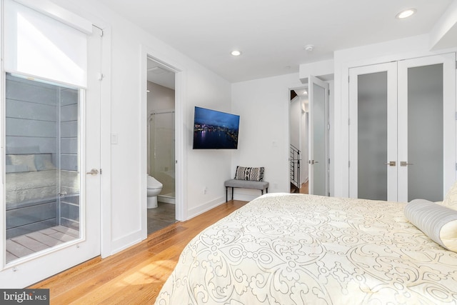 bedroom with wood-type flooring, a closet, and ensuite bathroom