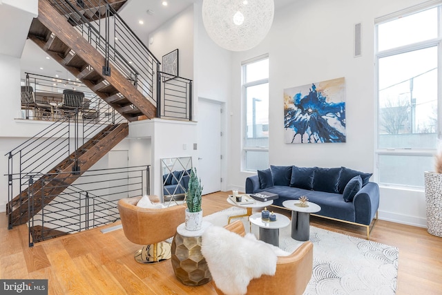 living room with hardwood / wood-style floors and a high ceiling