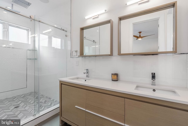 bathroom with tasteful backsplash, vanity, and a shower with shower door