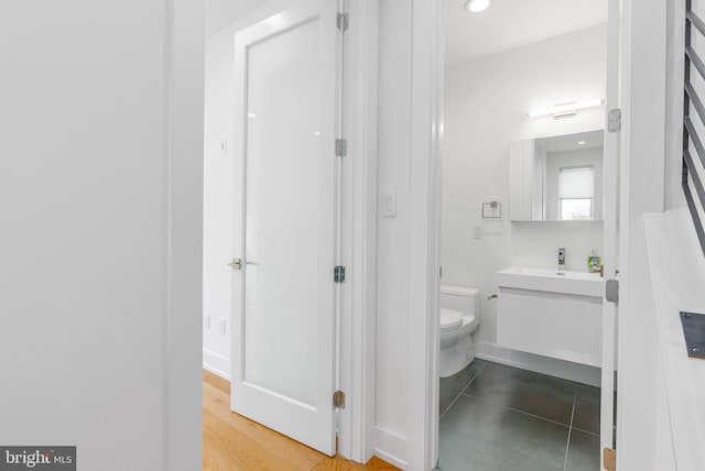 bathroom with vanity, toilet, and tile patterned flooring