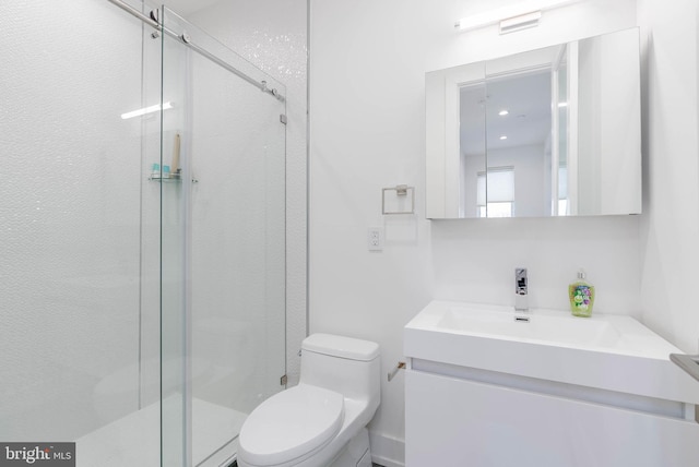 bathroom with vanity, walk in shower, and toilet