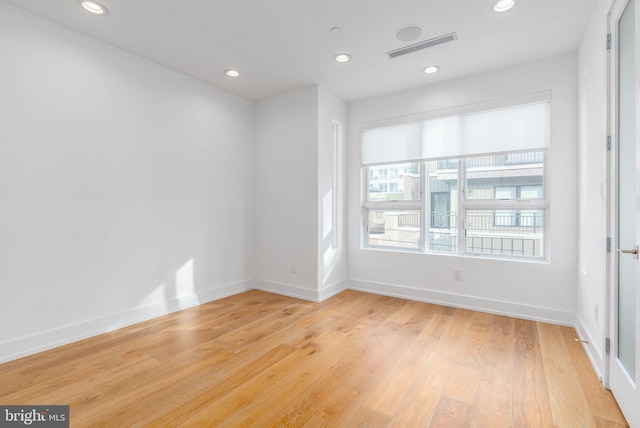 unfurnished room with light hardwood / wood-style floors